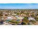 A panoramic aerial view of a neighborhood featuring many houses, pools and mature trees in a quiet setting at 12222 S Appaloosa Dr, Phoenix, AZ 85044