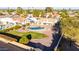 Aerial view of a sparkling pool and grassy yard featuring desert landscaping and lounge seating at 12222 S Appaloosa Dr, Phoenix, AZ 85044