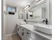 Bathroom featuring double sink vanity with marble countertops and modern black faucets at 12222 S Appaloosa Dr, Phoenix, AZ 85044