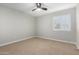 Bedroom featuring a ceiling fan and large window with natural light at 12222 S Appaloosa Dr, Phoenix, AZ 85044