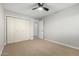 Bedroom featuring a ceiling fan, and a closet with large doors for ample storage at 12222 S Appaloosa Dr, Phoenix, AZ 85044