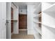 Walk-in closet with built-in shelving and hanging rods for ample storage space at 12222 S Appaloosa Dr, Phoenix, AZ 85044