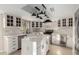 Updated kitchen featuring an island with quartz countertops, white cabinetry and stainless appliances at 12222 S Appaloosa Dr, Phoenix, AZ 85044