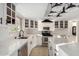 Modern kitchen featuring white cabinetry, quartz countertops and stainless steel appliances at 12222 S Appaloosa Dr, Phoenix, AZ 85044