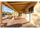 Outdoor covered patio with brick flooring offering a view of the desert landscape and pool area at 12222 S Appaloosa Dr, Phoenix, AZ 85044