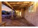 Covered patio with brick flooring offering a cozy outdoor living space, with easy access to the pool at 12222 S Appaloosa Dr, Phoenix, AZ 85044