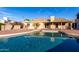 Inviting pool area with brick surround and backyard access to home at 12222 S Appaloosa Dr, Phoenix, AZ 85044