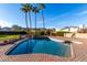 Refreshing pool with a spa and mature palm trees offering a relaxing outdoor experience on a sunny day at 12222 S Appaloosa Dr, Phoenix, AZ 85044