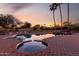 Relaxing pool and spa area with brick accents and desert landscaping, perfect for outdoor enjoyment at 12222 S Appaloosa Dr, Phoenix, AZ 85044