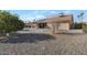 Rear exterior showing drought tolerant yard, covered patio, solar panels, and desert landscaping at 12323 W Fieldstone Dr, Sun City West, AZ 85375