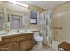 Functional bathroom featuring a vanity and a shower-tub combination with curtain at 12323 W Fieldstone Dr, Sun City West, AZ 85375