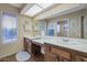 Bright bathroom featuring double sinks, counter space, and tile floors at 12323 W Fieldstone Dr, Sun City West, AZ 85375