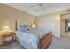 Comfortable bedroom featuring neutral walls, ceiling fan, and convenient closet at 12323 W Fieldstone Dr, Sun City West, AZ 85375