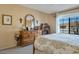 Bedroom with natural wood furniture and a large sunny window at 12323 W Fieldstone Dr, Sun City West, AZ 85375