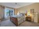 Cozy bedroom with carpet, ceiling fan, and natural light from the large window at 12323 W Fieldstone Dr, Sun City West, AZ 85375