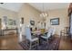 Elegant dining area with vaulted ceilings, chandelier lighting, and access to other rooms at 12323 W Fieldstone Dr, Sun City West, AZ 85375