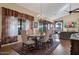 Elegant dining room featuring wood floors, large windows, and a decorative chandelier at 12323 W Fieldstone Dr, Sun City West, AZ 85375