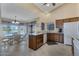 Bright kitchen features white appliances, granite counters, and breakfast nook with large windows at 12323 W Fieldstone Dr, Sun City West, AZ 85375