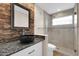 Modern bathroom with stone accent wall, vessel sink, granite counters, and glass shower at 13234 N 2Nd St, Phoenix, AZ 85022