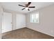 Spare bedroom with tile floors, ceiling fan, window with shutters, and closet at 13234 N 2Nd St, Phoenix, AZ 85022