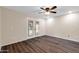 Bright bedroom with wood flooring, ceiling fan, and French doors leading to pool at 13234 N 2Nd St, Phoenix, AZ 85022