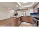 Open-concept kitchen with granite countertops, stainless steel appliances, and a view into the living area at 13234 N 2Nd St, Phoenix, AZ 85022