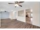 Spacious living room with hardwood floors, neutral walls, and an adjacent fireplace and kitchen at 13234 N 2Nd St, Phoenix, AZ 85022