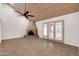 Inviting living room with vaulted ceilings, a rustic fireplace, and natural light from patio doors at 13234 N 2Nd St, Phoenix, AZ 85022