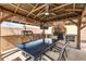 Outdoor kitchen and dining area under a charming pergola with a built-in grill at 13234 N 2Nd St, Phoenix, AZ 85022