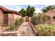 Charming garden pathway with arched trellises leading to a wooden gate at 13234 N 2Nd St, Phoenix, AZ 85022