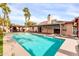 Exterior view of sparkling blue pool and outdoor kitchen with covered pergola at 13234 N 2Nd St, Phoenix, AZ 85022