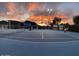 Outdoor tennis court with bright lighting for evening matches at sunset at 13234 N 2Nd St, Phoenix, AZ 85022