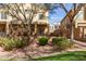 Backyard view of outdoor patio with dining table and chairs and a small garden at 1350 S Greenfield Rd # 1215, Mesa, AZ 85206