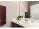 A modern bathroom with a white vanity, a large mirror, and brown accent towels at 1350 S Greenfield Rd # 1215, Mesa, AZ 85206