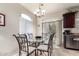 This dining nook features a glass table, seating for six, and a sliding glass door to the outdoor patio at 1350 S Greenfield Rd # 1215, Mesa, AZ 85206