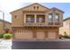 Stately exterior showcasing a three-car garage and a private balcony at 1350 S Greenfield Rd # 1215, Mesa, AZ 85206