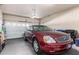 Garage with car parked in front of a garage door and shelving at 1350 S Greenfield Rd # 1215, Mesa, AZ 85206