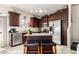 This kitchen features stainless steel appliances, a breakfast bar island with seating, and decorative elements at 1350 S Greenfield Rd # 1215, Mesa, AZ 85206