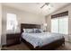 Spacious main bedroom with large bed, side tables with lamps, and a ceiling fan at 1350 S Greenfield Rd # 1215, Mesa, AZ 85206