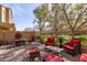 This outdoor patio features red seating, a brick-paver floor, and a view of the lawn and surrounding landscape at 1350 S Greenfield Rd # 1215, Mesa, AZ 85206