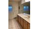 Bathroom features a white countertop, wood cabinets and tiled floors at 150 W Tam Oshanter Dr, Phoenix, AZ 85023