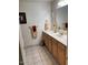 Bathroom with white countertop, wood cabinets and decorative towels at 150 W Tam Oshanter Dr, Phoenix, AZ 85023