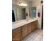 Bathroom with a white countertop, decorative towels and wood cabinets at 150 W Tam Oshanter Dr, Phoenix, AZ 85023