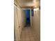 Tiled hallway features a closet, decorative lighting and access to other rooms at 150 W Tam Oshanter Dr, Phoenix, AZ 85023