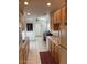 Long galley kitchen featuring oak cabinets, a double sink and an adjoining office space at 150 W Tam Oshanter Dr, Phoenix, AZ 85023