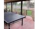 Covered patio with ping pong table overlooking the lawn at 150 W Tam Oshanter Dr, Phoenix, AZ 85023