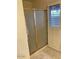 Shower with glass door and white shutters at 150 W Tam Oshanter Dr, Phoenix, AZ 85023