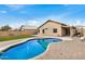 This backyard features a pool, covered patio and turf, a perfect space for outdoor living and entertaining at 1565 E 10Th St, Casa Grande, AZ 85122