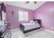 A serene bedroom featuring purple walls, a comfortable bed and a dresser to keep your clothes organized at 1565 E 10Th St, Casa Grande, AZ 85122