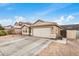 Nice home featuring a two-car garage, desert landscaping, and paved driveway at 1565 E 10Th St, Casa Grande, AZ 85122